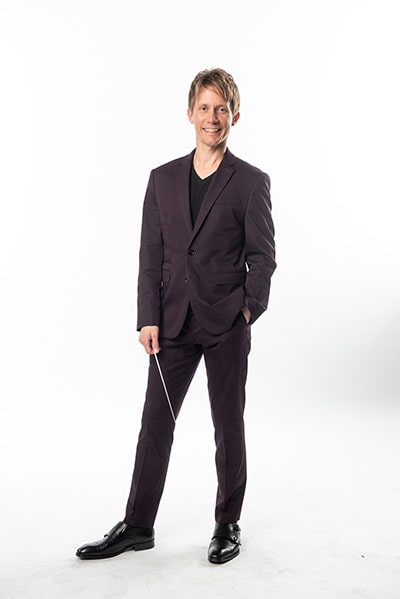 Scott Seaton in a dark suit with a white background