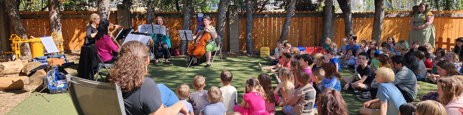 musicians playing for a classroom of kids