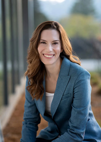 Dana Savada in a blue jacket smiling